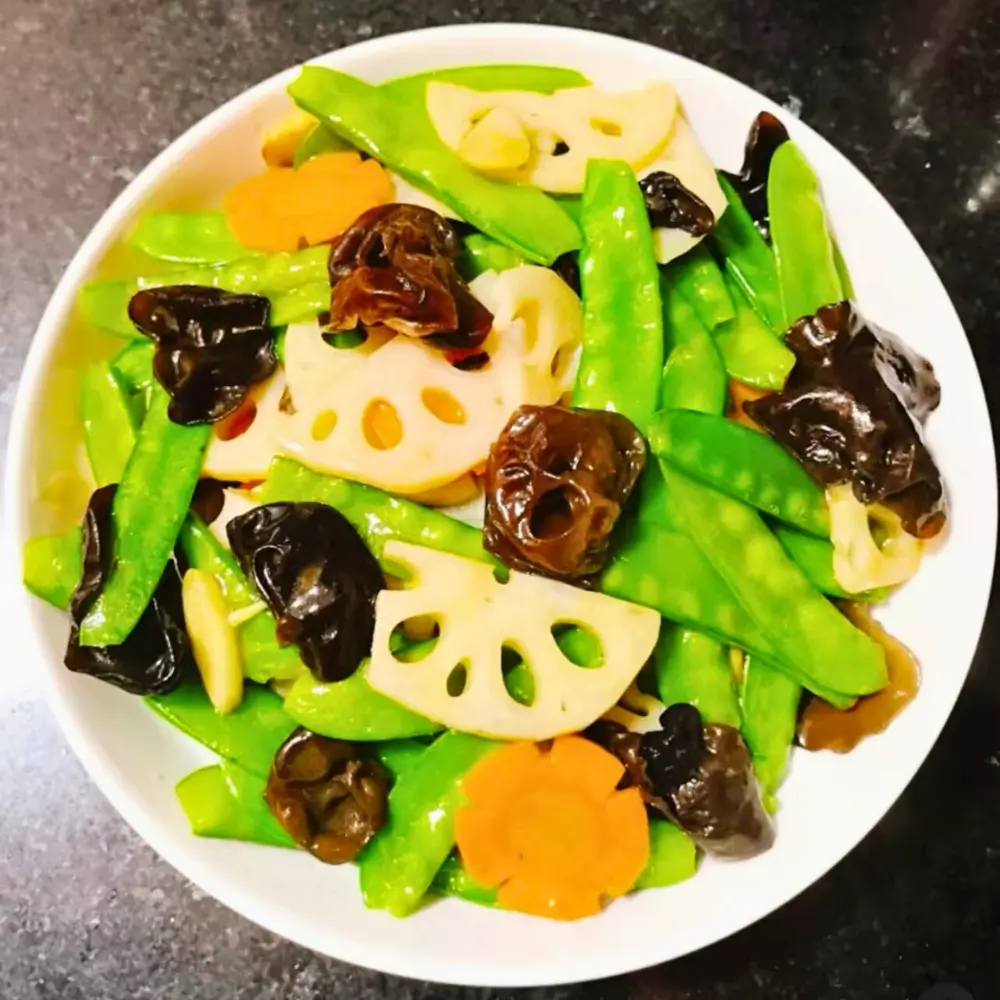 Stir-fried lotus root and snow peas at Dallas Spicy Chinese Cuisine, a Chinese Restaurant in Plano.