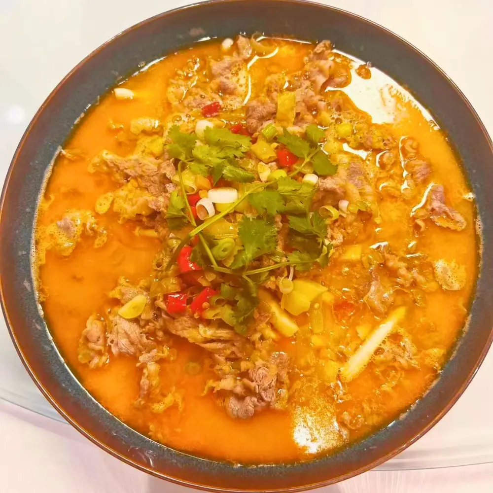 Sour soup with beef slices and herbs at Dallas Spicy Chinese Cuisine, a Chinese Restaurant in Plano.