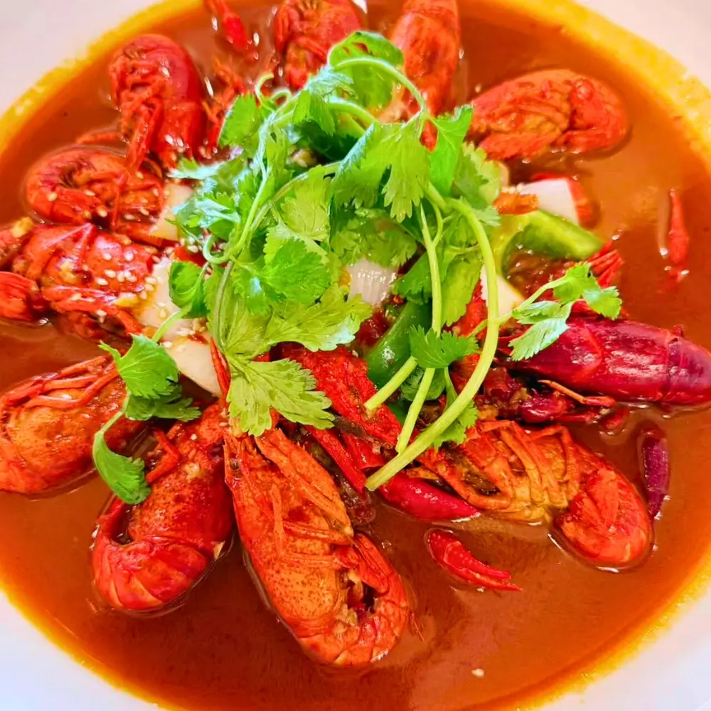 Spicy crayfish garnished with cilantro at Dallas Spicy Chinese Cuisine, a Chinese Restaurant in Plano.