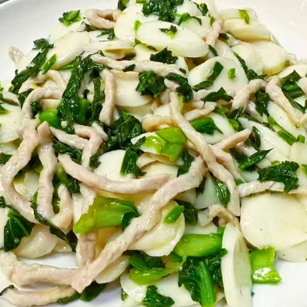 Stir-fried rice cake with pork and salted meat at Dallas Spicy Chinese Cuisine, a Chinese Restaurant in Plano.